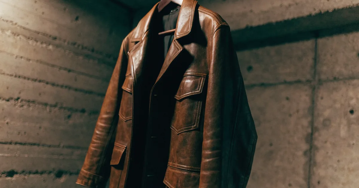 Vintage leather jacket on a hanger against concrete — grailed fee calculator for commission and net profit